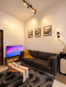 a living room with a couch and a flat screen tv at Casa Aelliah in General Santos