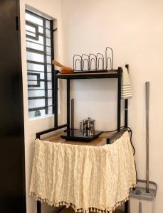 a black shelf with a pot on it next to a window at Casa Aelliah in General Santos