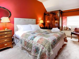a bedroom with a large bed and red walls at Wanton Wa's in Edinburgh