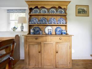 a wooden cabinet with blue and white dishes on it at Wanton Wa's in Edinburgh