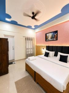 a bedroom with two beds and a ceiling at Anamika Forest View 1RK Near Kempty Falls Mussoorie in Mussoorie +2 photos