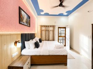 a bedroom with a large bed and a ceiling at Anamika Forest View 1RK Near Kempty Falls Mussoorie in Mussoorie