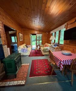 a living room with a table and a couch at The Cabin at The Oaks in Fordingbridge