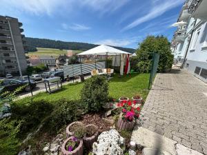 a garden with flowers and a white tent at La belle Époque in Tramelan