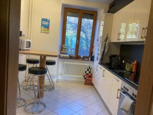 a kitchen with a table and some stools in it at La belle Époque in Tramelan