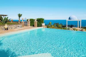 a swimming pool with the ocean in the background at Buena Vista in Letojanni +72 photos
