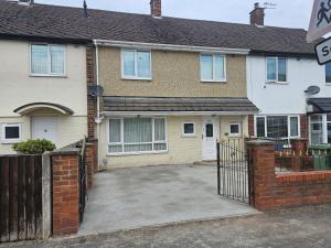 a house with a gate and a driveway at Leasowe House in Bidston