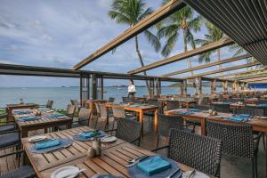 a restaurant on the beach with tables and chairs at Bandara Spa Resort & Pool Villas, Samui in Bophut