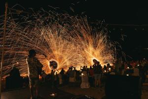a crowd of people watching a fire show at night at Bandara Spa Resort & Pool Villas, Samui in Bophut +146 photos