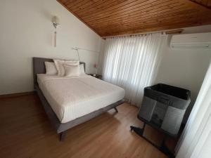 a bedroom with a bed and a window at Oran House in Ayvalık