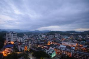 a view of a city at night with mountains at Grand Mandarin Betong Hotel in Betong