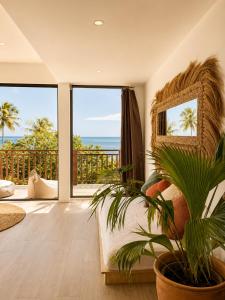 a bedroom with a bed and a view of the ocean at Samura Panorama Guest House in Thulusdhoo