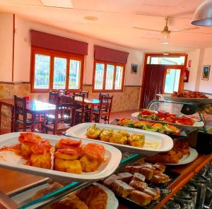 a buffet with many plates of food on a table at Hostal de Berge in Berge