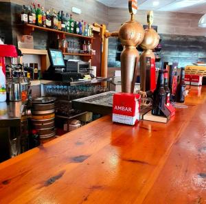 a bar with an american sign on a wooden counter at Hostal de Berge in Berge