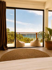 a room with a large window with a view at Samura Panorama Guest House in Thulusdhoo