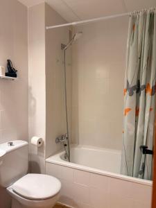 a bathroom with a shower and a toilet and a tub at Agradable y rústico, perfecto para parejas - Cuc 7 in Pla de l'Ermita +34 photos