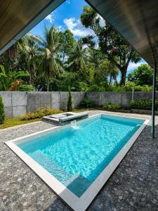 a swimming pool in the middle of a yard at Villa Droom Nest Manado in Manado