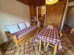 a room with a couch and a table in a kitchen at Studio Crêt du Midi, Chez Francine in Notre-Dame-de-Bellecombe +22 photos