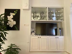 a white hutch with a television in it at Oran House in Ayvalık