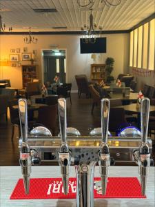 a table with two pairs of tongs in a restaurant at Inn On The Lake in Gravesend