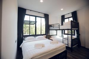 a bedroom with two bunk beds and a window at Issara Private Pool Villa Khaoyai in Pak Chong +76 photos