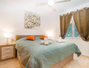 a bedroom with a large bed with two pillows at Villa SOFIA - Costa Blanca in Benissa