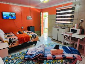 a room with two beds and a kitchen with a sink at 48 ON Lindi in Welkom