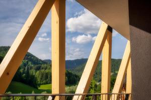 a view from the balcony of a building looking out at the mountains at NaturHotel Snovik in Kamnik