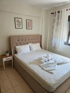 a bedroom with a bed with towels on it at Nice apartment with amazing views in Kriopigi