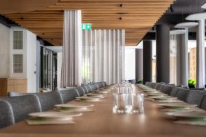 a long table in a room with chairs at NaturHotel Snovik in Kamnik +38 photos