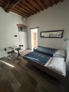 a bedroom with a bed and a table in it at La stanzetta in Carrara