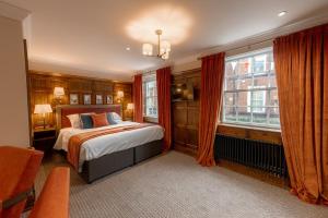a bedroom with a bed and a large window at Angel @ KingSt in Knutsford