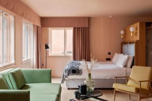 a bedroom with a bed and two chairs and a table at Whitworth Locke in Manchester