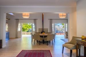 a dining room with a table and chairs at Stony Brook Cottages in Franschhoek