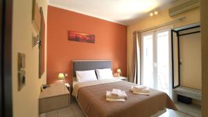 a bedroom with a bed with two towels on it at Oliva Resort View & Swimming pool Studios in Parga