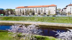 a river in front of a building and a road at King Mindaugas center apartment in Kaunas