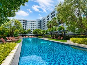 a swimming pool in front of a building at Easy Access Studio Near BTS in Amphoe Phra Khanong