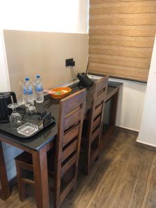 a table with chairs and bottles of water on it at Kithulgala Cabana Resort in Kitulgala