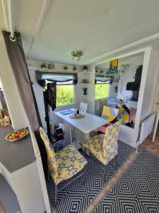 a kitchen and dining area of a rv with a table and chairs at Airport Cottage in Aldergrove +3 photos