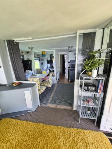 a living room with a yellow rug and a living room at Airport Cottage in Aldergrove