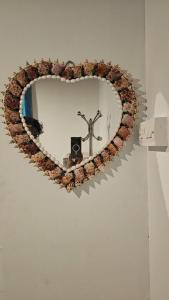 a heart shaped wreath with a cross and a camera at WildCliff pool huts in Meppādi