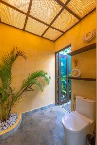 a bathroom with a toilet and a plant at Tanaw Villas in General Luna +57 photos