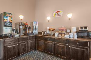 a coffee shop with wooden cabinets and a counter top at Super 8 by Wyndham Oklahoma City in Oklahoma City