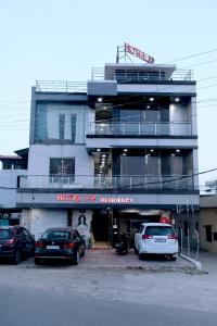 a building with cars parked in front of it at Hotel J P Residency in Datia