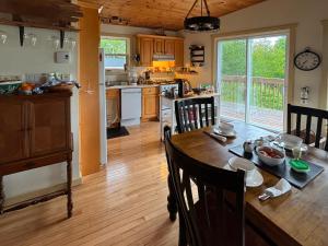 a kitchen and dining room with a wooden table with chairs at Sunrise Place Bed & Breakfast in DʼEscousse +33 photos