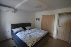 a bedroom with a bed and a wooden cabinet at Slovenia Valley Views in Lipa pri Frankolovem