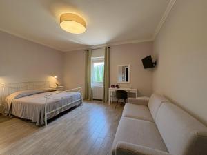 a bedroom with a bed and a couch and a desk at Agriturismo Villa Luisa in Apice +34 photos