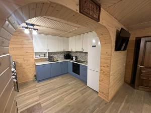 a kitchen with an arch in the middle of it at Андріана in Mykulychyn +13 photos