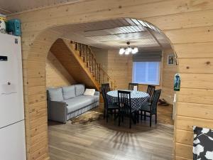 a living room with a table and a couch at Андріана in Mykulychyn