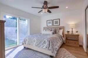 a bedroom with a bed and a ceiling fan at Beautiful Remodel 3 Bedroom 2 bathroom Home with Pool & Jacuzzi in Fullerton +21 photos